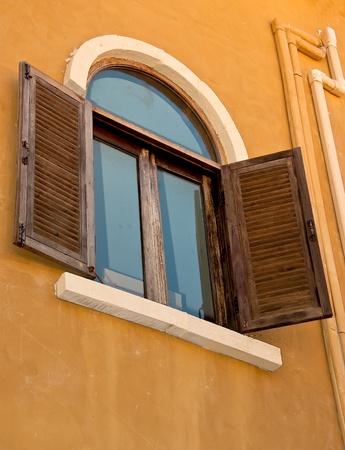 Vintage window on orange  cement wall can be used for backgroundの写真素材