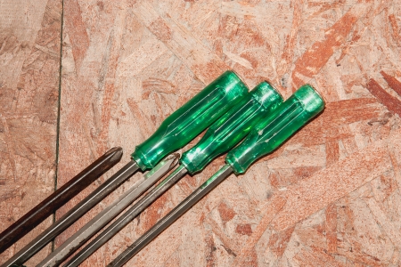 Group of screwdrivers on wood wall background
