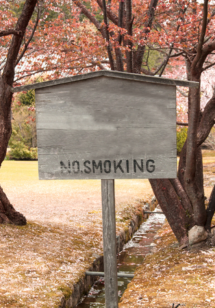 Wooden sign symbol no smoking in the garden の写真素材