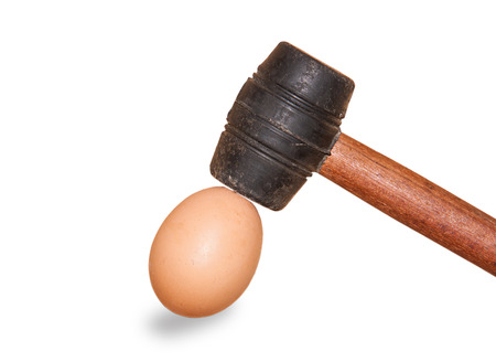 rubber hammer hit to the eggs isolated on white の写真素材