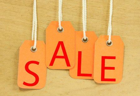 Sale Price tag hanging  with on wooden の写真素材