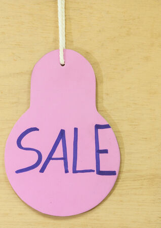 Sale Price tag hanging  with on wooden for backgroundの写真素材