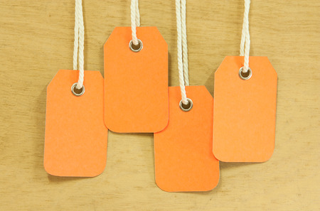 blank price tag hang on wooden backgroundの写真素材