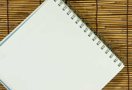 Open notebook with  white  on bamboo backgroundの写真素材