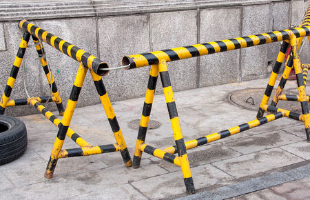 Yellow and black iron fence for traffic.