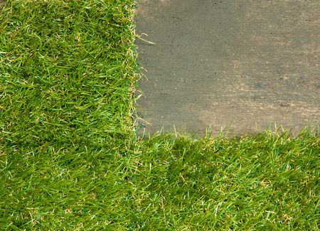 Artificial grass placed on the wooden floor.の写真素材