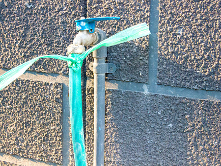 The wall mounted faucet and hose.の写真素材