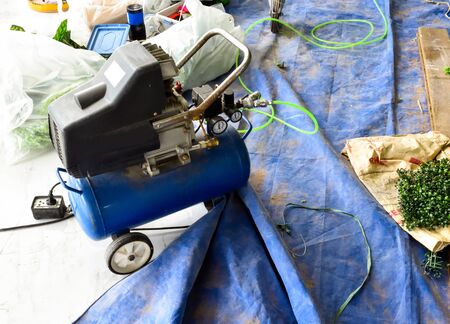 The old blue Air compressor in the construction area.の写真素材