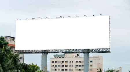 Billboard with empty screen, against blue skyの写真素材