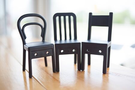 Small black toy chair in a beautiful cornerの写真素材