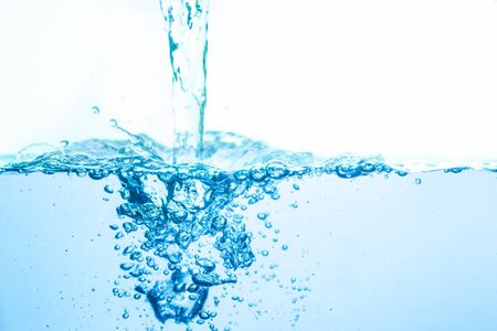 Pour blue water and have white background bubbles.の写真素材