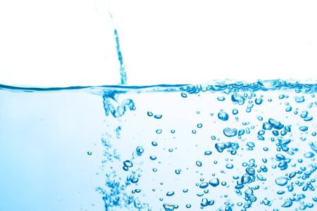Blue water flowing, lots of small bubbles, bright white backgroundの写真素材
