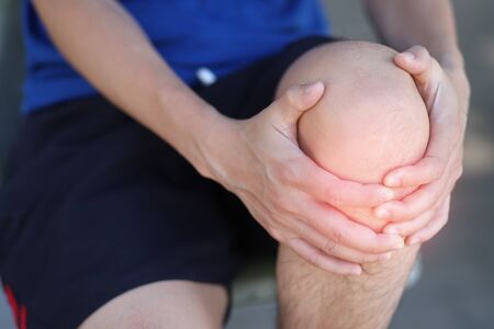 Young runners hurt their knees. Healthy love conceptの写真素材