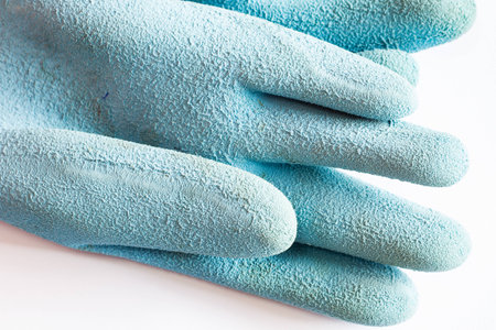 Used rubber gloves isolated on whiteの写真素材