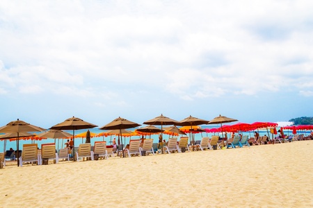 colorful beach umbrella and deck chairs on the tropical beachのeditorial素材