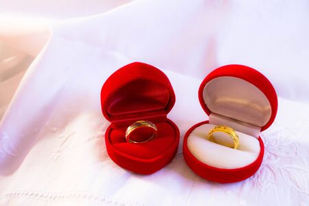 Wedding rings on red box whith white cloth background