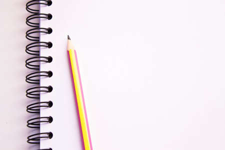 white sketch book and pencil isolated on whiteの写真素材