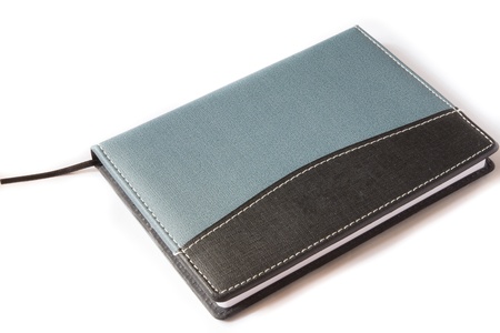 blue and black note book on a white backgroundの写真素材