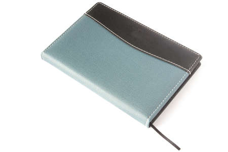 blue and black note book on a white backgroundの写真素材