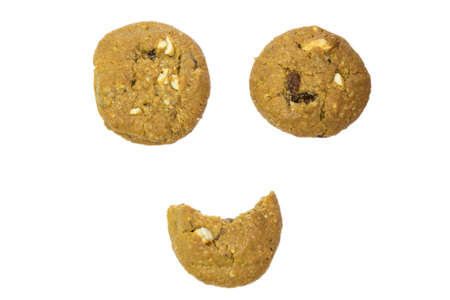 pile of chocolate chip cookies bite smile  isolated on a white backgroundの写真素材