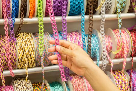Female hand select many ribbon for packing giftsの写真素材