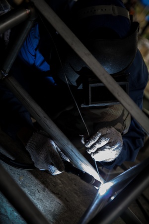 Welder with sparks arcing.