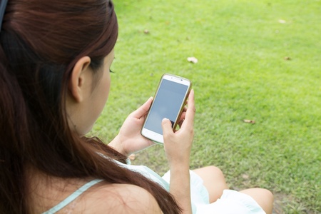 Young woman working on a mobile deviceの写真素材