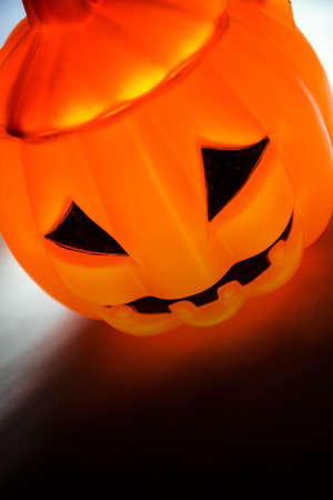 Halloween pumpkin with scary face with reflection on blackの写真素材