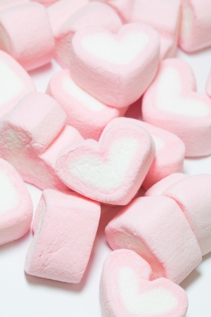 pink Marshmallows of heart shape, on white backgroundsの写真素材