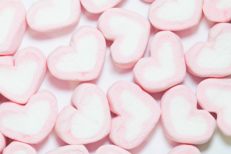pink Marshmallows of heart shape, on white backgroundsの写真素材