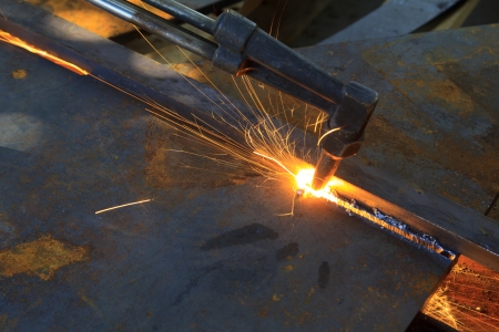 metal cutting with acetylene torch, industrial background