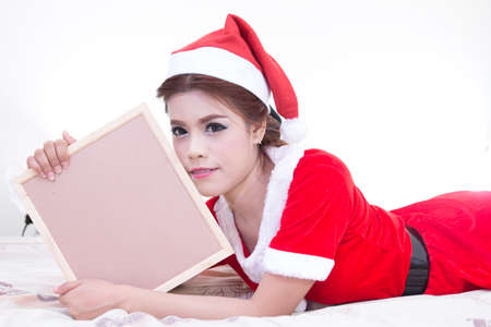 Beautiful women asian hold wood board in red santa dress. christmas conceptの写真素材