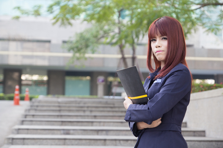 asian beautiful business woman with folder at modern buildingの写真素材