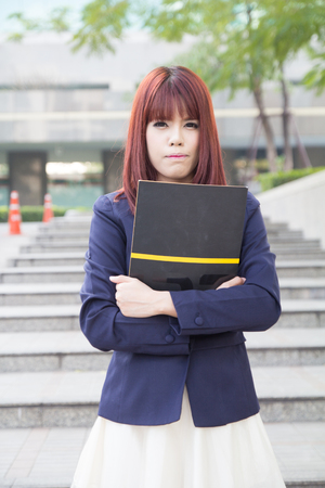 asian beautiful business woman with folder at modern buildingの写真素材