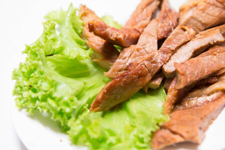 Fried pork and lettuce on white dish
