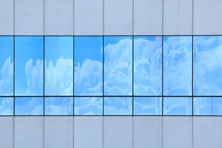 Clouds reflected in windows of modern office buildingのeditorial素材