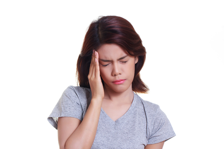 young woman with a headache holding headの写真素材