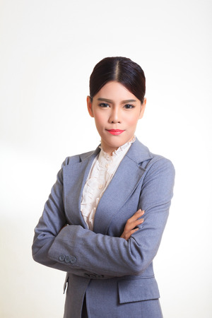 Business woman wearing a suit, standing arms crossed, smiling with confidence.の写真素材