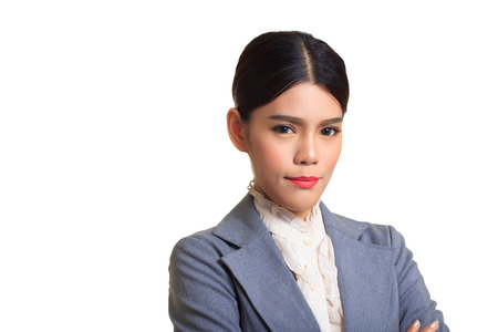 Business woman wearing a suit, standing arms crossed, smiling with confidence.の写真素材