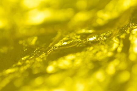 Gold creased paper background texture. Gold paper sheet.(Blur Focus)の写真素材