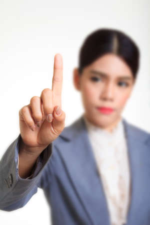 Business woman pointing her finger on imaginery virtual buttonの写真素材