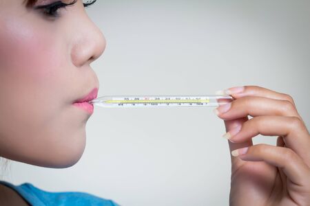 Sick woman  show hand holding clinical  thermometer