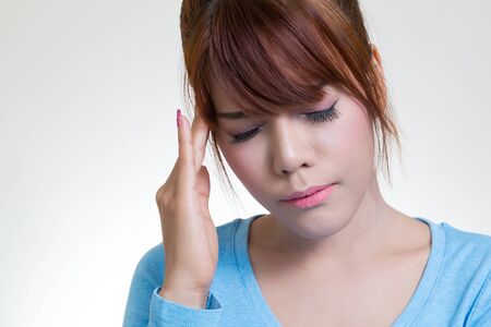 Young asian woman with headache, migraine, stress, insomnia, hangoverの写真素材