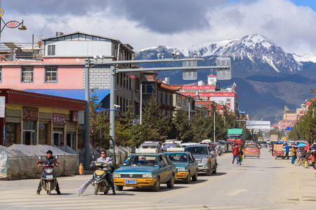 SHANGRI-LA, CHINA - April 20, 2016:Traffic intersection in the Shangri-la city with the snow mountains background.のeditorial素材