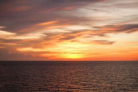 Sunset at sea with beautiful clouds in the evening and twilight timeの写真素材