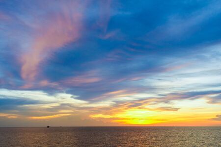Sunset at sea with beautiful clouds in the evening and twilight timeの写真素材