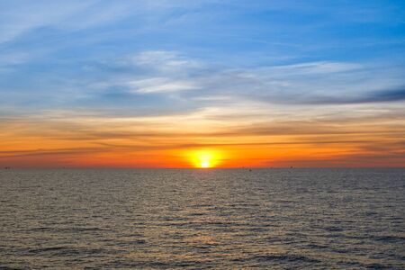 Sunset at sea with beautiful clouds in the evening and twilight timeの写真素材