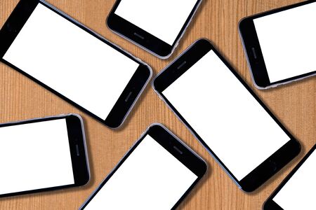 Group of Smartphone with blank white screen On Wooden Table for mocup you display montageの写真素材