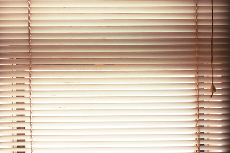 window blinds open with blur natural view background in vintage tone.
