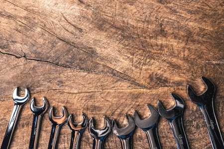Top view of group of wrench arrange on wooden rustic background. flat lay with copy space for mechanic tools concept.の写真素材